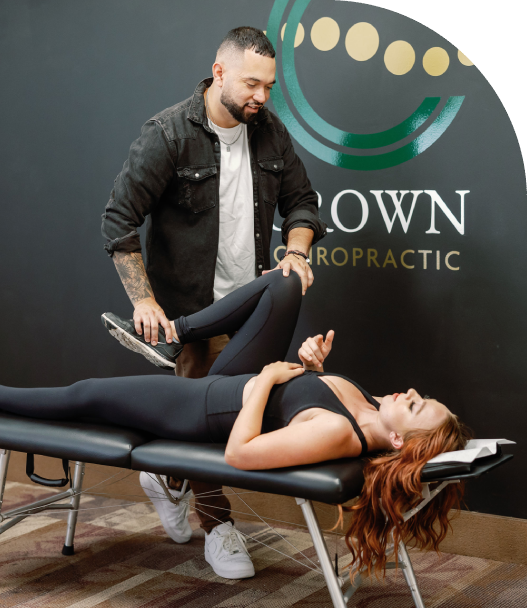 Group Chiropractor stretching patient's leg muscles