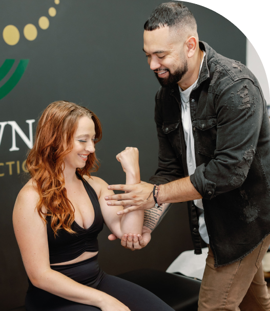 Chiropractor examining patient's elbow mobility